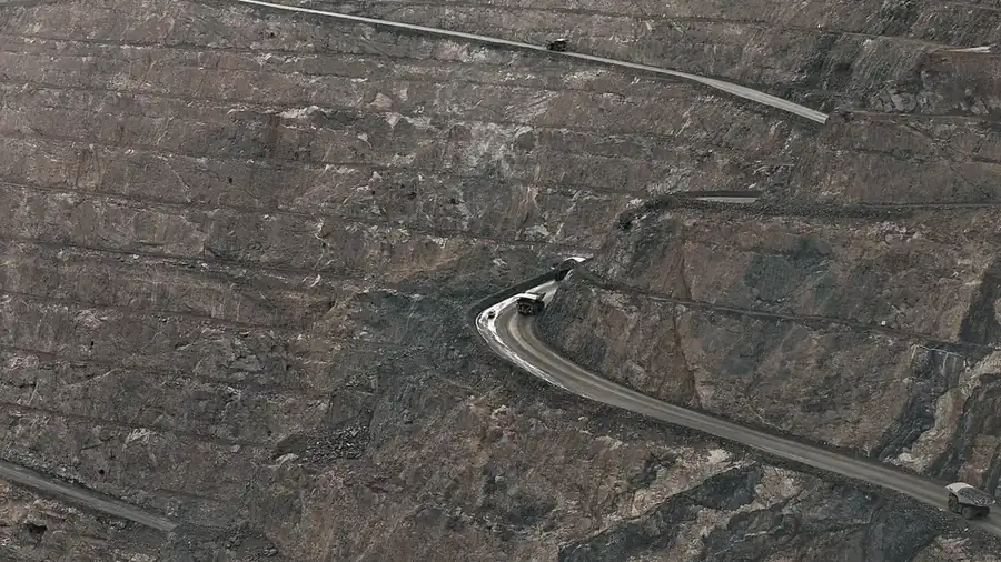 Vista aérea de uma cava, com a estrada de serviço acompanhando a borda das bancadas